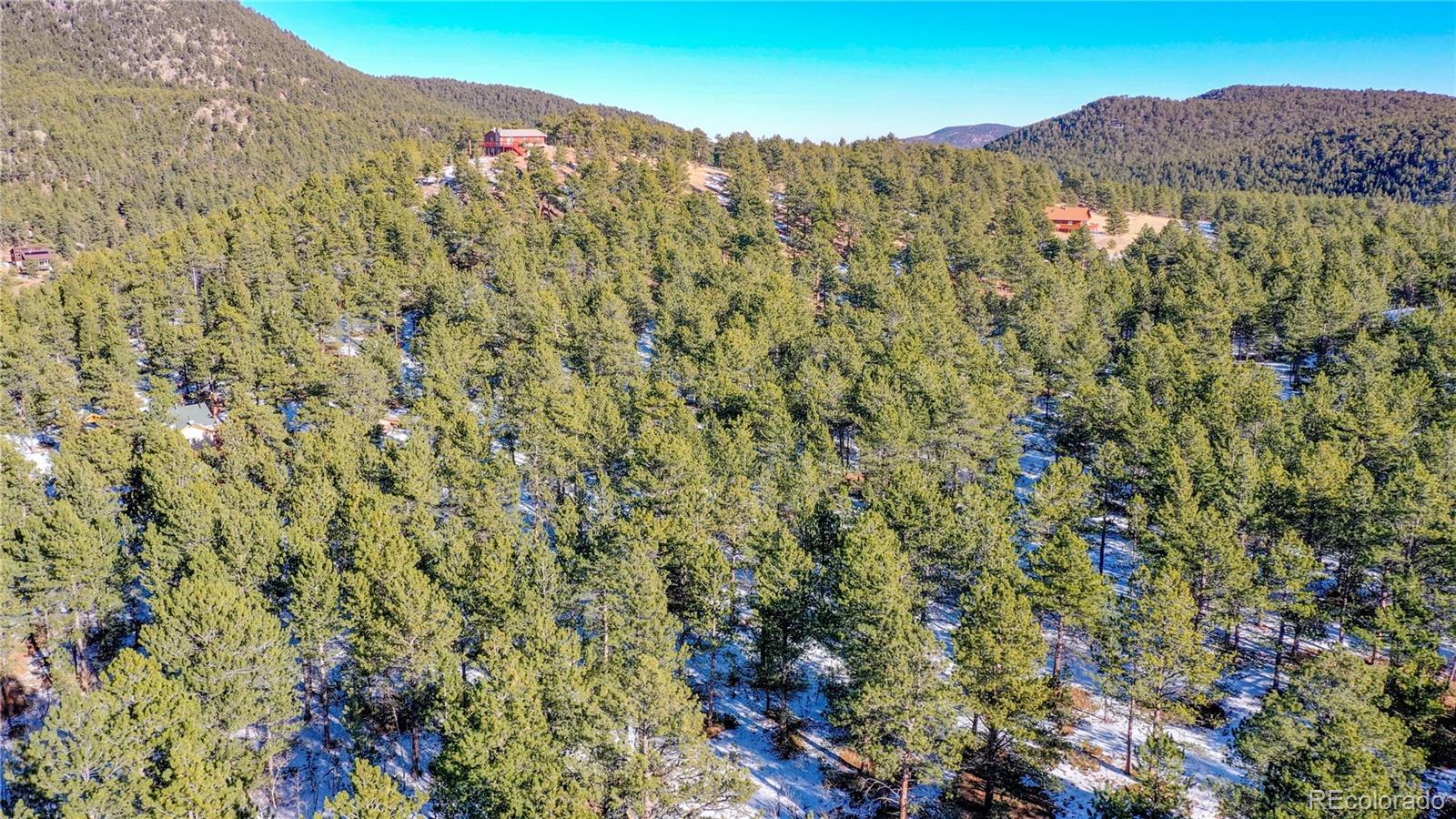 357 Big John Road Lyons, CO 80540 - Photo 12 of 17 a view of a dry yard with mountains in the background