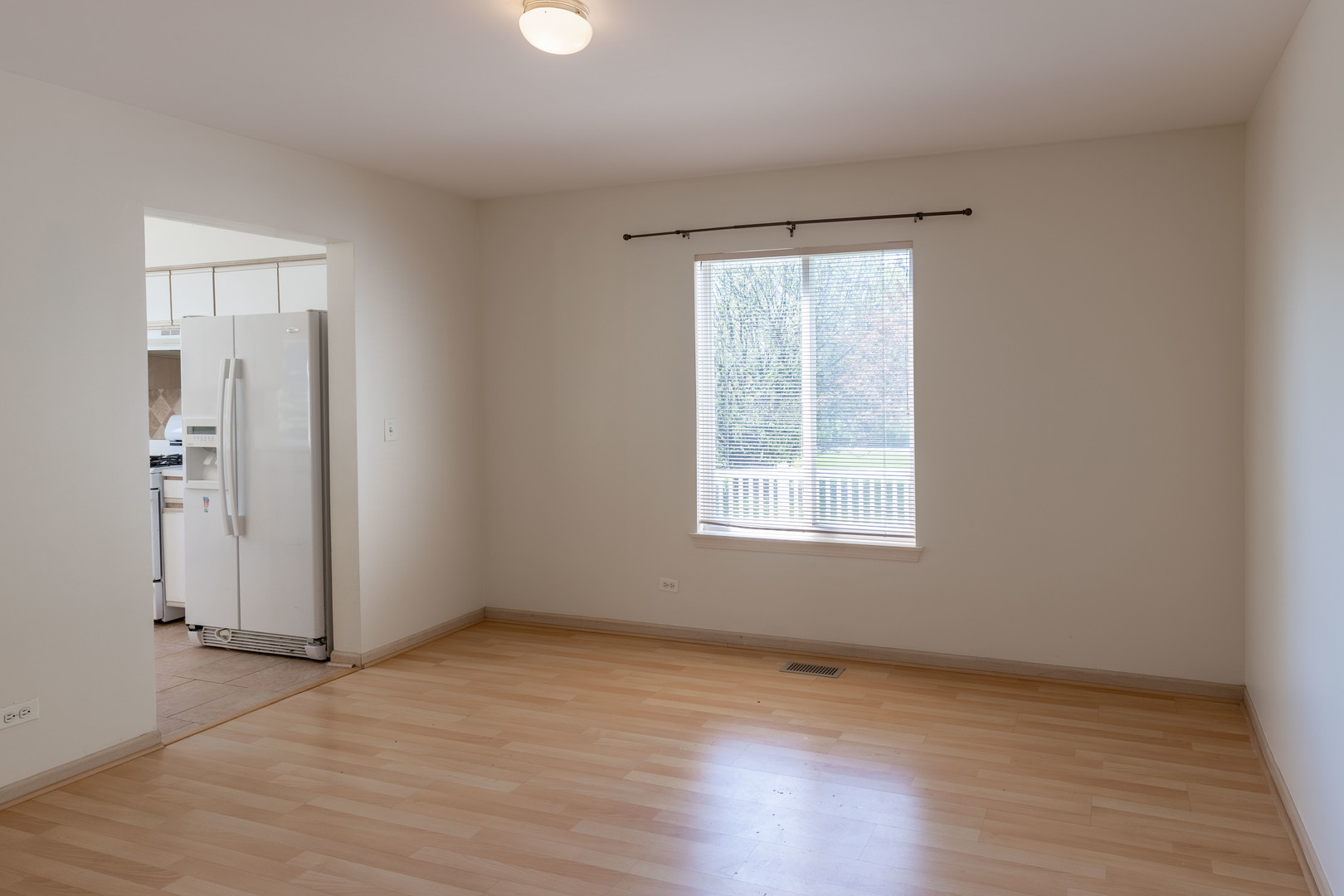 643 Maple Drive Streamwood, IL 60107 - Photo 12 of 32 an empty room with wooden floor and windows