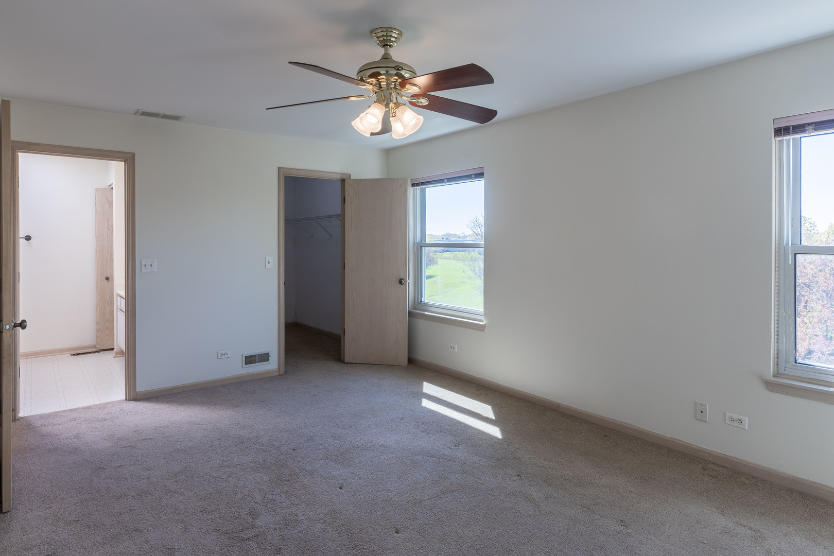 643 Maple Drive Streamwood, IL 60107 - Photo 15 of 32 an empty room with windows and fan