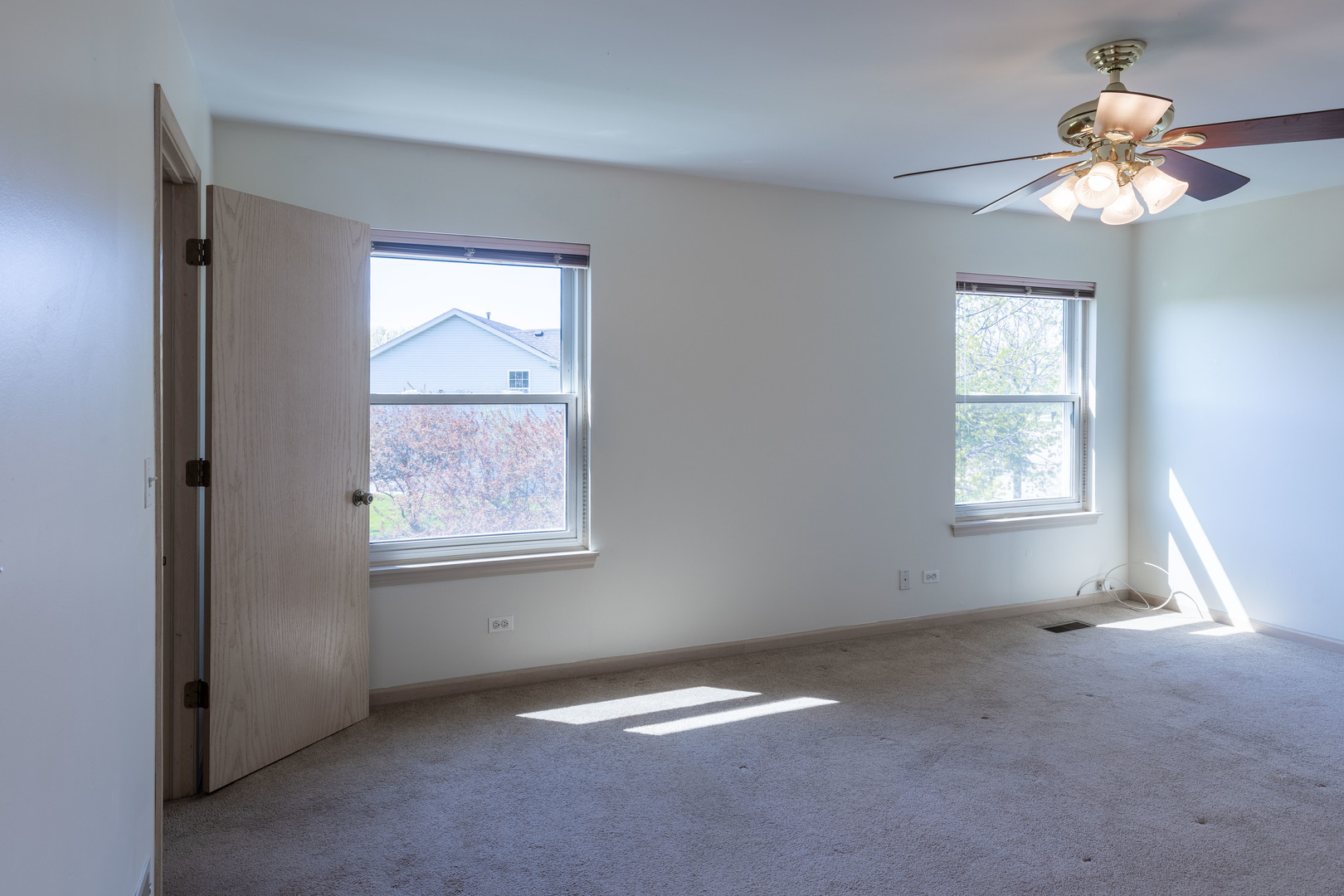 643 Maple Drive Streamwood, IL 60107 - Photo 16 of 32 an empty room with windows and fan