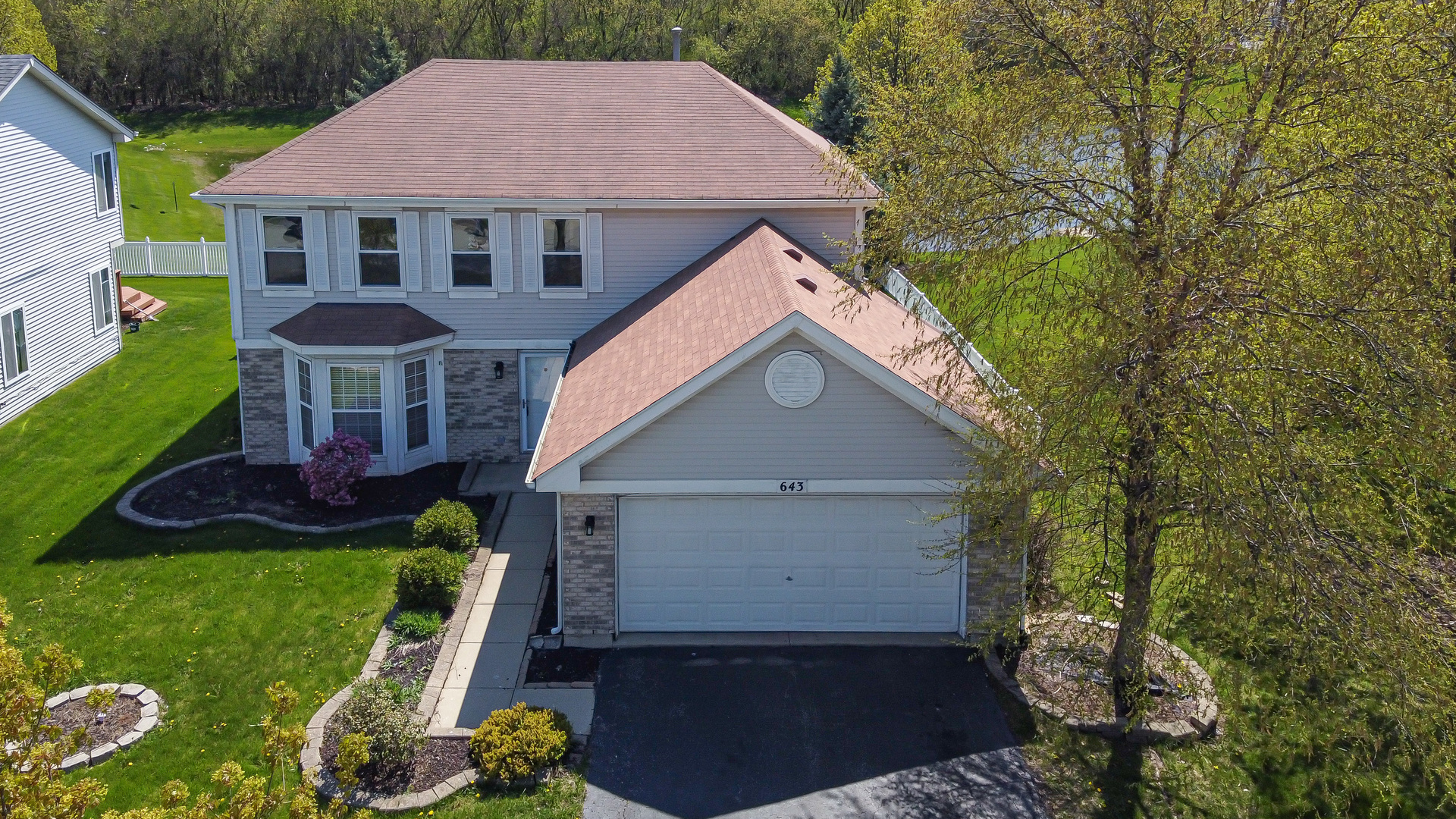 643 Maple Drive Streamwood, IL 60107 - Photo 2 of 32 a front view of a house with garden
