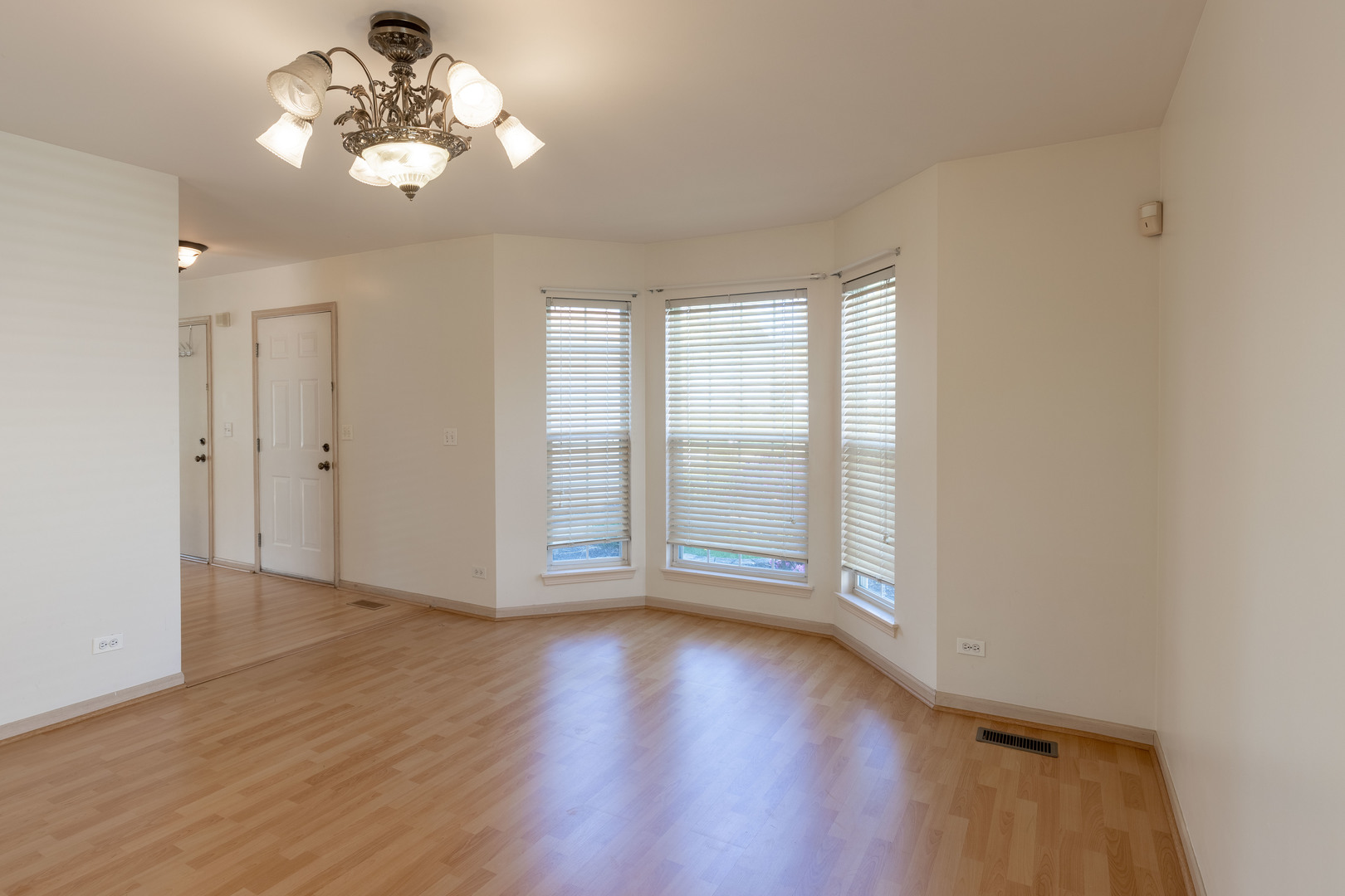643 Maple Drive Streamwood, IL 60107 - Photo 4 of 32 an empty room with wooden floor and windows
