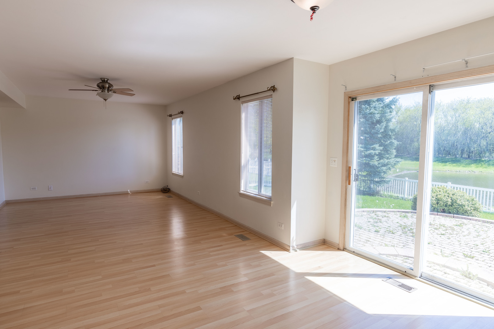 643 Maple Drive Streamwood, IL 60107 - Photo 9 of 32 an empty room with wooden floor and windows