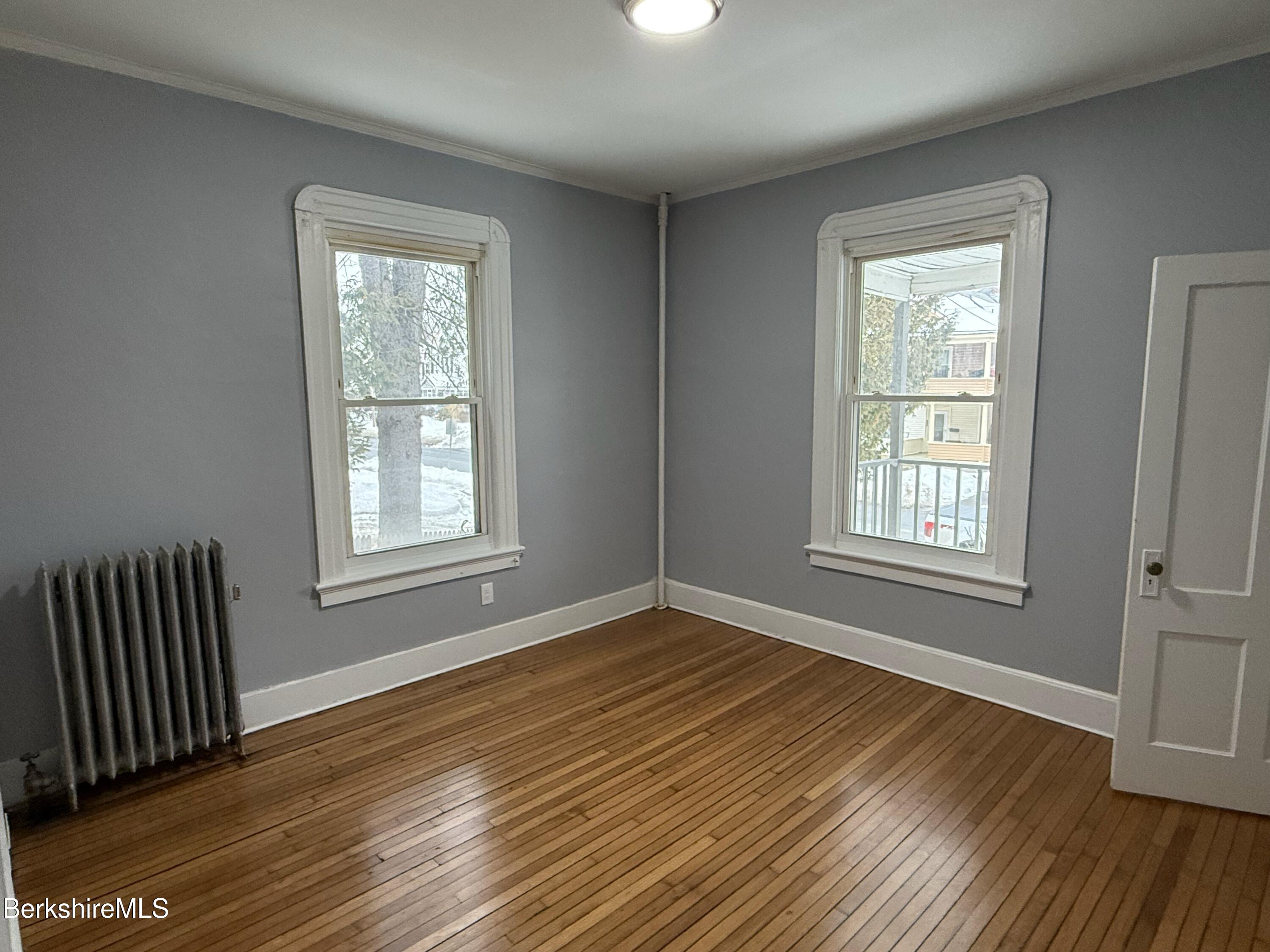 124 Appleton Avenue, Unit 1 Pittsfield, MA 01201 - Photo 5 of 10 a view of an empty room with wooden floor and a window