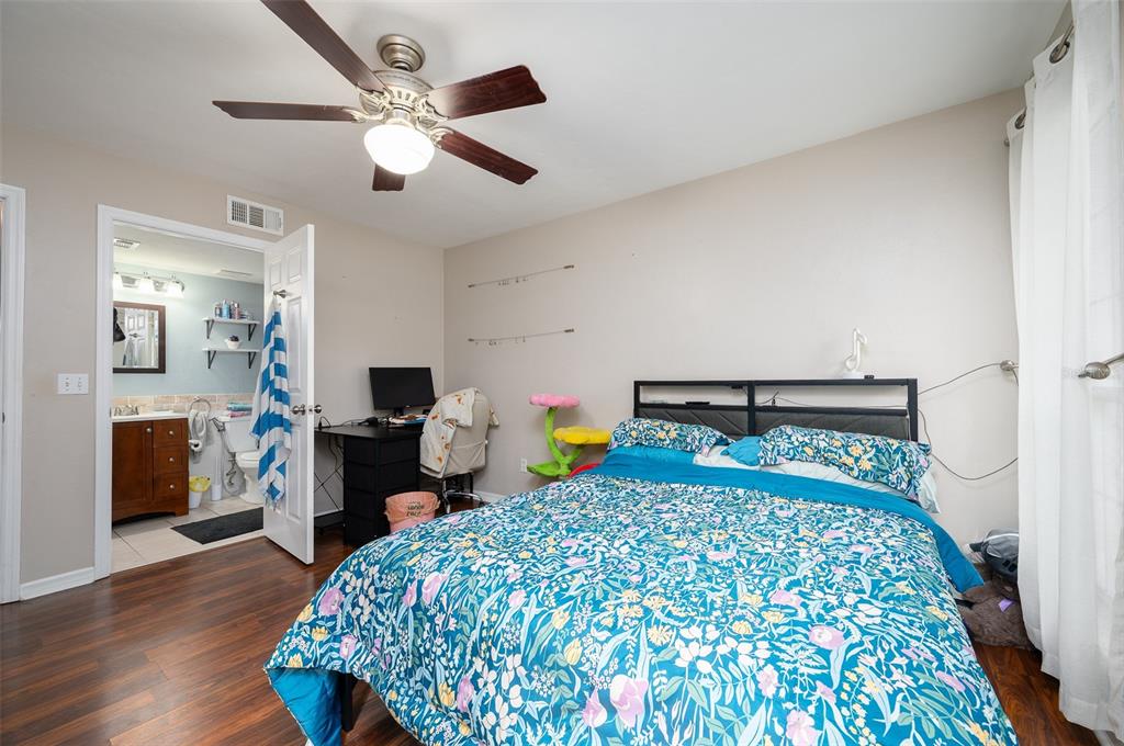 900 Southwest 62nd Boulevard, Unit H49 Gainesville, FL 32607 - Photo 16 of 38 a bedroom with a bed and wooden floor