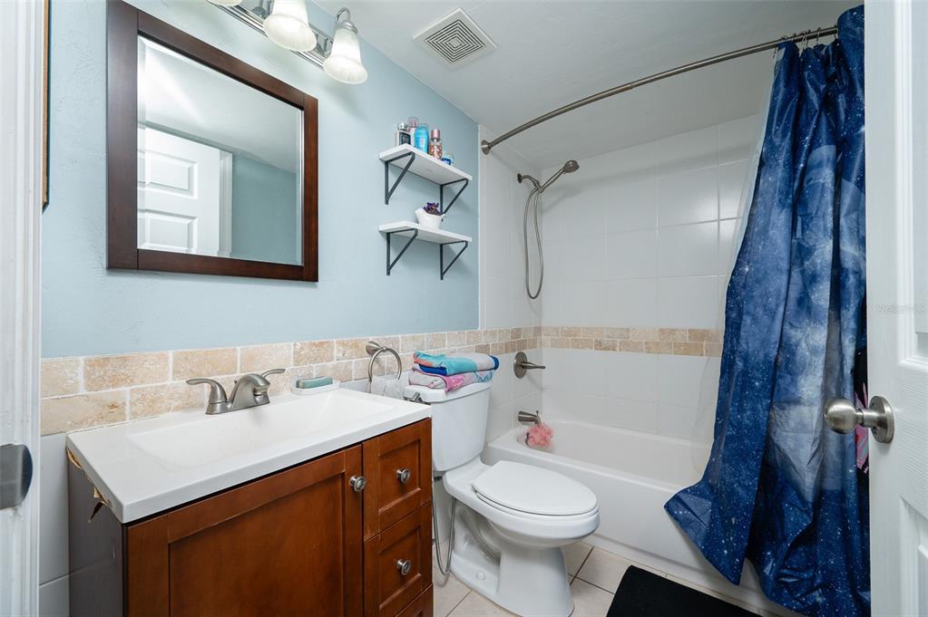 900 Southwest 62nd Boulevard, Unit H49 Gainesville, FL 32607 - Photo 17 of 38 a bathroom with a sink vanity mirror and toilet