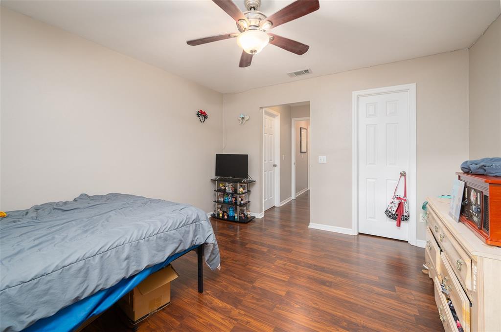 900 Southwest 62nd Boulevard, Unit H49 Gainesville, FL 32607 - Photo 19 of 38 a bedroom with a bed and a flat screen tv
