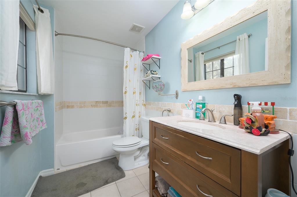 900 Southwest 62nd Boulevard, Unit H49 Gainesville, FL 32607 - Photo 20 of 38 a bathroom with a sink vanity mirror bathtub and toilet