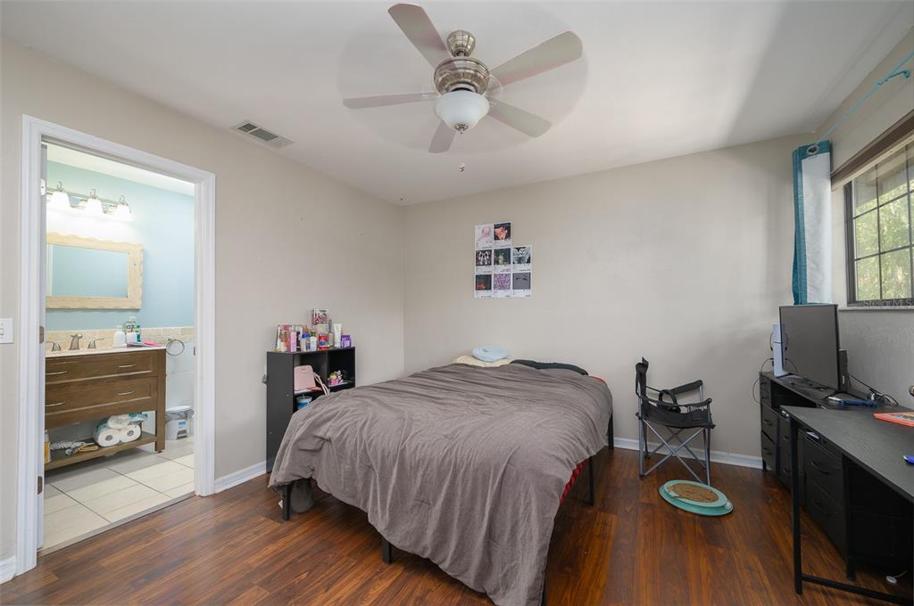 900 Southwest 62nd Boulevard, Unit H49 Gainesville, FL 32607 - Photo 22 of 38 a bedroom with a bed and a flat screen tv