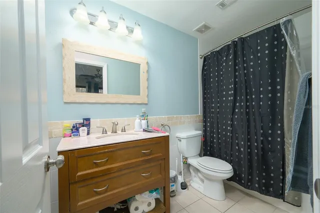 a bathroom with a sink vanity mirror and toilet