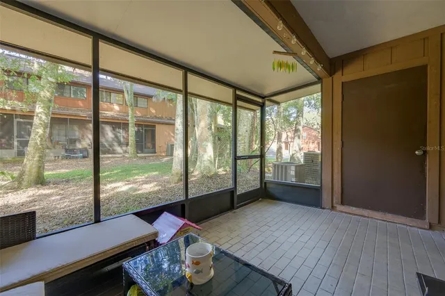 a living room with furniture and a floor to ceiling window