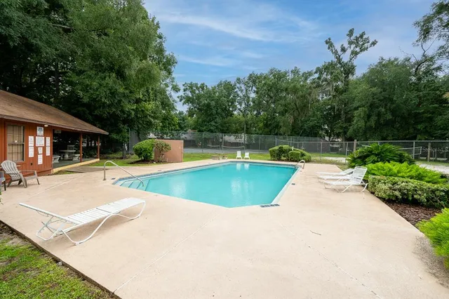 a view of swimming pool with a patio and a yard