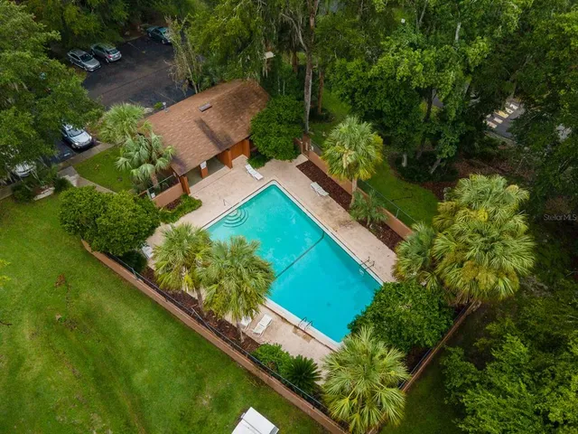an aerial view of a house with a yard