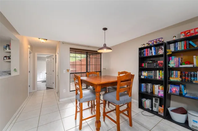 a dining room with furniture and a book shelf