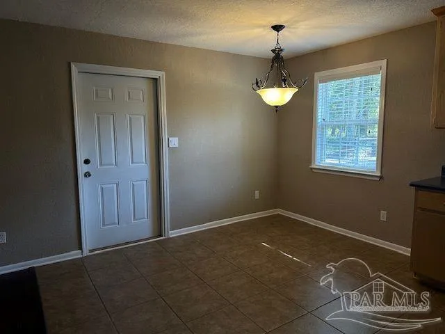a bathroom with a granite countertop sink a toilet a mirror and shower curtain