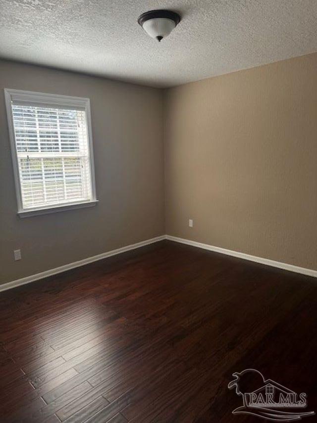 4071 Diamond Street Pace, FL 32571 - Photo 14 of 19 an empty room with wooden floor and windows