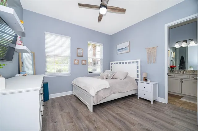 a bedroom with a bed and a table chair