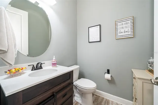 a bathroom with a sink mirror vanity and toilet