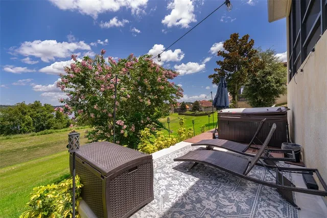 a view of a backyard with sitting area