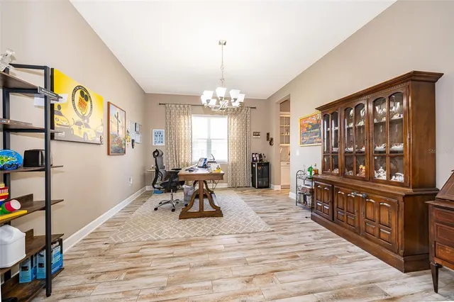 a living room with furniture a window and a flat screen tv