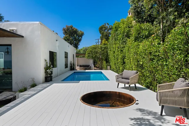 a bathroom with a tub a sink and a shower