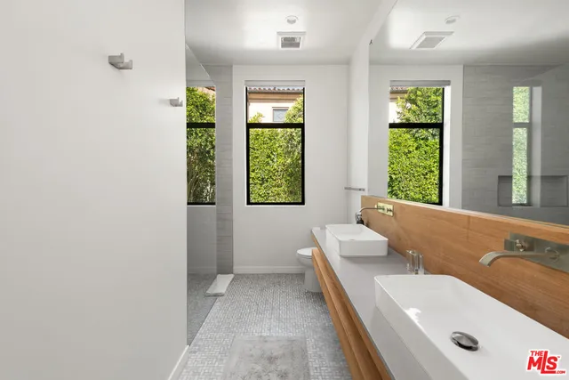 a large bedroom with a bed and large windows