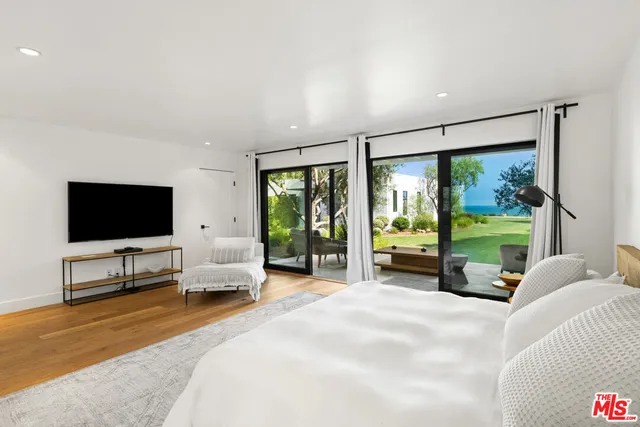 a living room with furniture and a floor to ceiling window