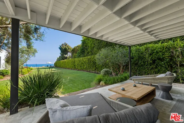 a living room with furniture and large windows