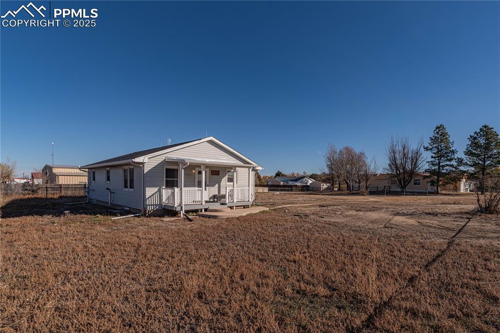 1075 8th Street Calhan, CO 80808 - Photo 2 of 45 a front view of a house with a yard