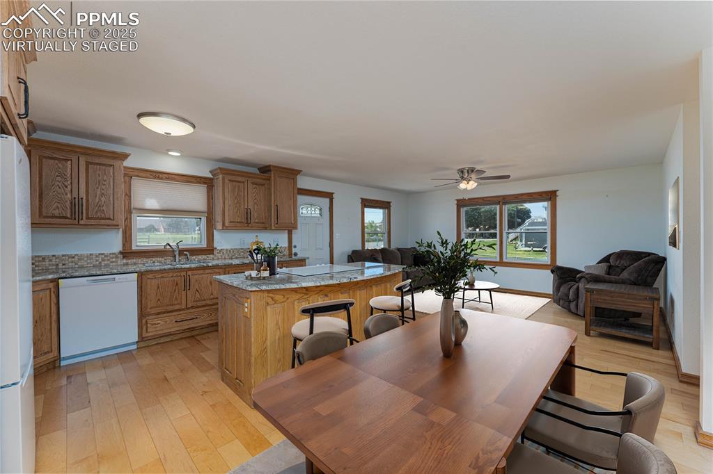 1075 8th Street Calhan, CO 80808 - Photo 3 of 45 a kitchen with a dining table chairs stainless steel appliances and cabinets