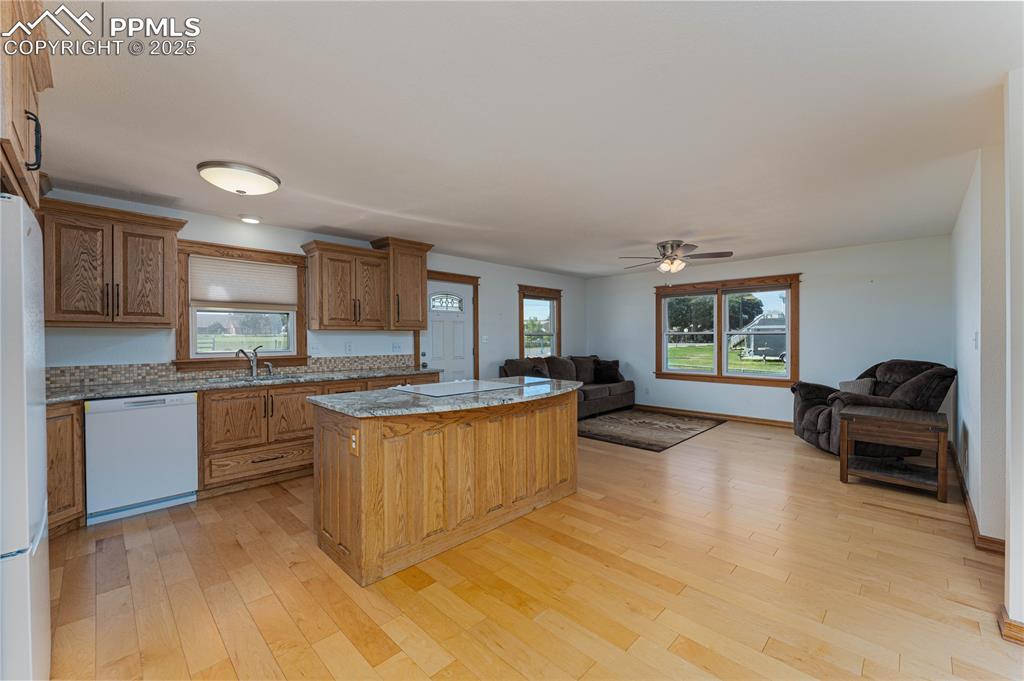 1075 8th Street Calhan, CO 80808 - Photo 36 of 45 a kitchen with granite countertop a stove and a sink