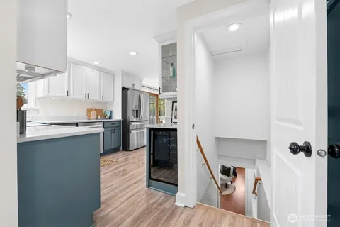 a kitchen with white cabinets and stainless steel appliances