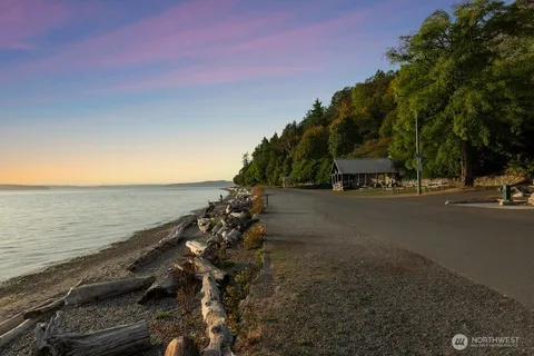 a view of a street with beach and trees
