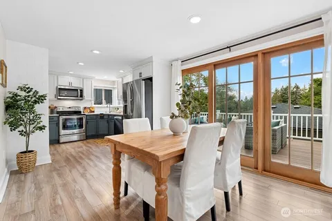 a view of a dining room with furniture window and wooden floor