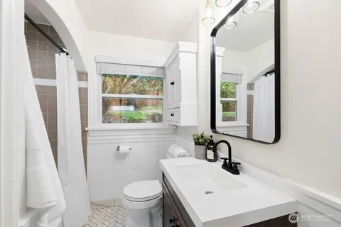 a bathroom with a sink toilet and a mirror