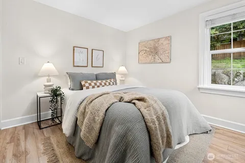 a bed sitting in a bedroom next to a window