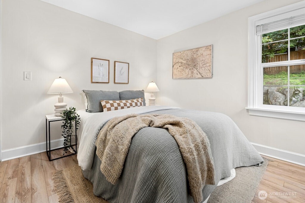 4431 Southwest Kenyon Place Seattle, WA 98136 - Photo 10 of 30 a bed sitting in a bedroom next to a window