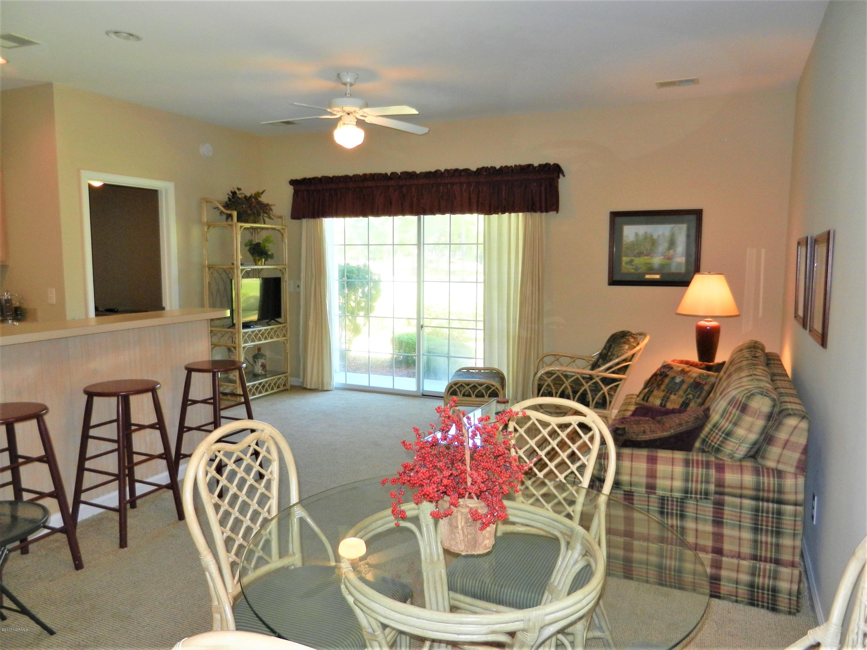 215 Royal Poste Road, Unit 2708 Sunset Beach, NC 28468 - Photo 4 of 28 Dining area looking from entry. Sliding door to patio facing golf course
