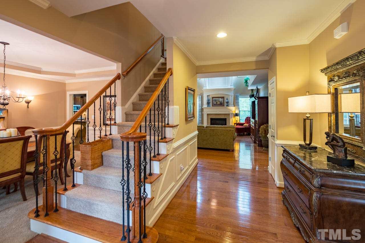 4445 Fairview Ridge Lane Apex, NC 27539 - Photo 3 of 30 Lovely wrought iron stair rails, hardwoods, and Study to the right. Dining room to the left.