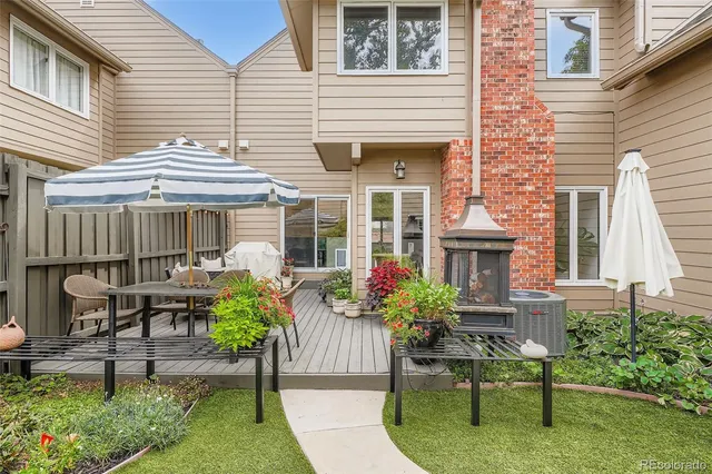 a view of a house with a chairs and table in a patio