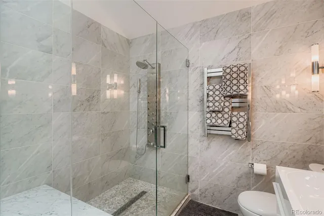 a bathroom with a shower toilet and sink