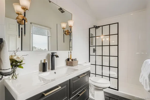 a bathroom with a sink toilet and shower