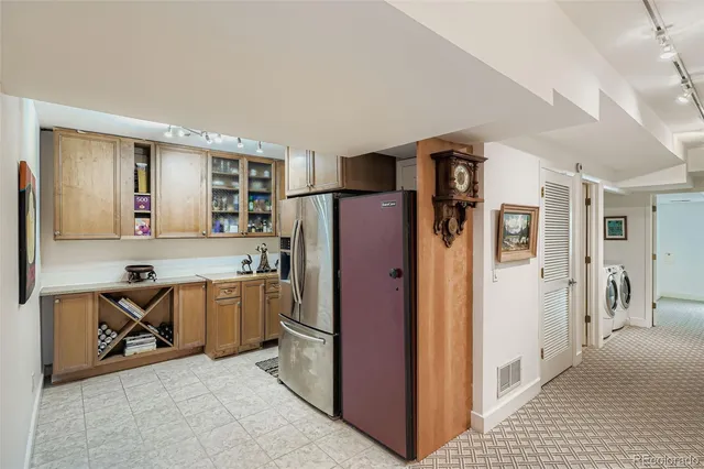 a kitchen with stainless steel appliances granite countertop a refrigerator and a stove