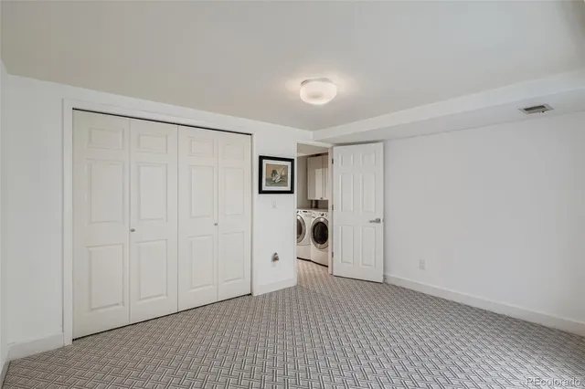 a view of a room with an empty space and a window