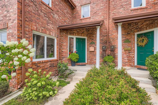 front view of a brick house with a large window