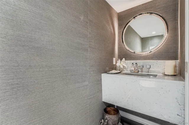 a bathroom with a sink mirror vanity and a mirror