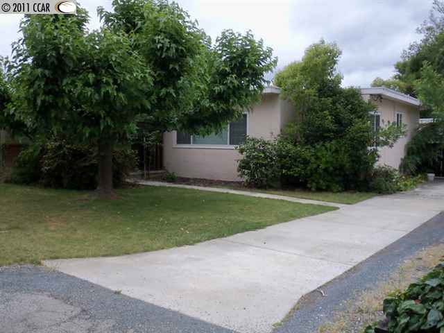 a view of a house with a yard and a garage