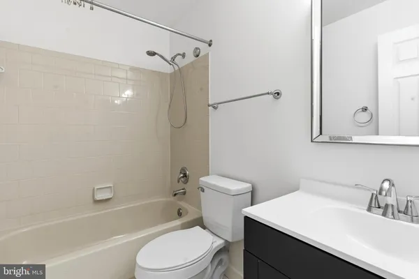 a bathroom with a sink toilet vanity and shower