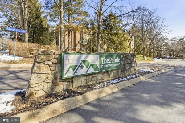 a street sign on a sidewalk next to a road
