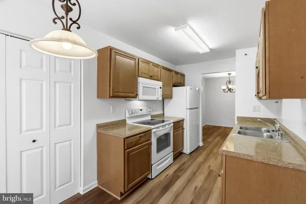 a kitchen with a stove sink and refrigerator